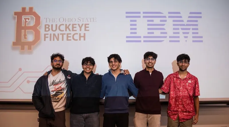Five students standing in front of a Buckeye FinTech and IBM slide