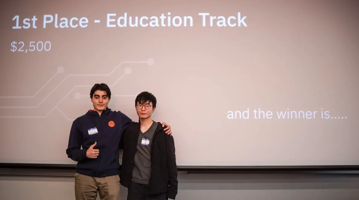 The first-place Education track team in front of the winner announcement slide
